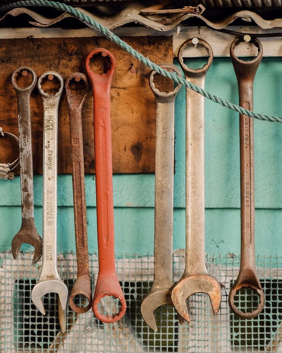 Wrenches hung in size order on a shop wall.